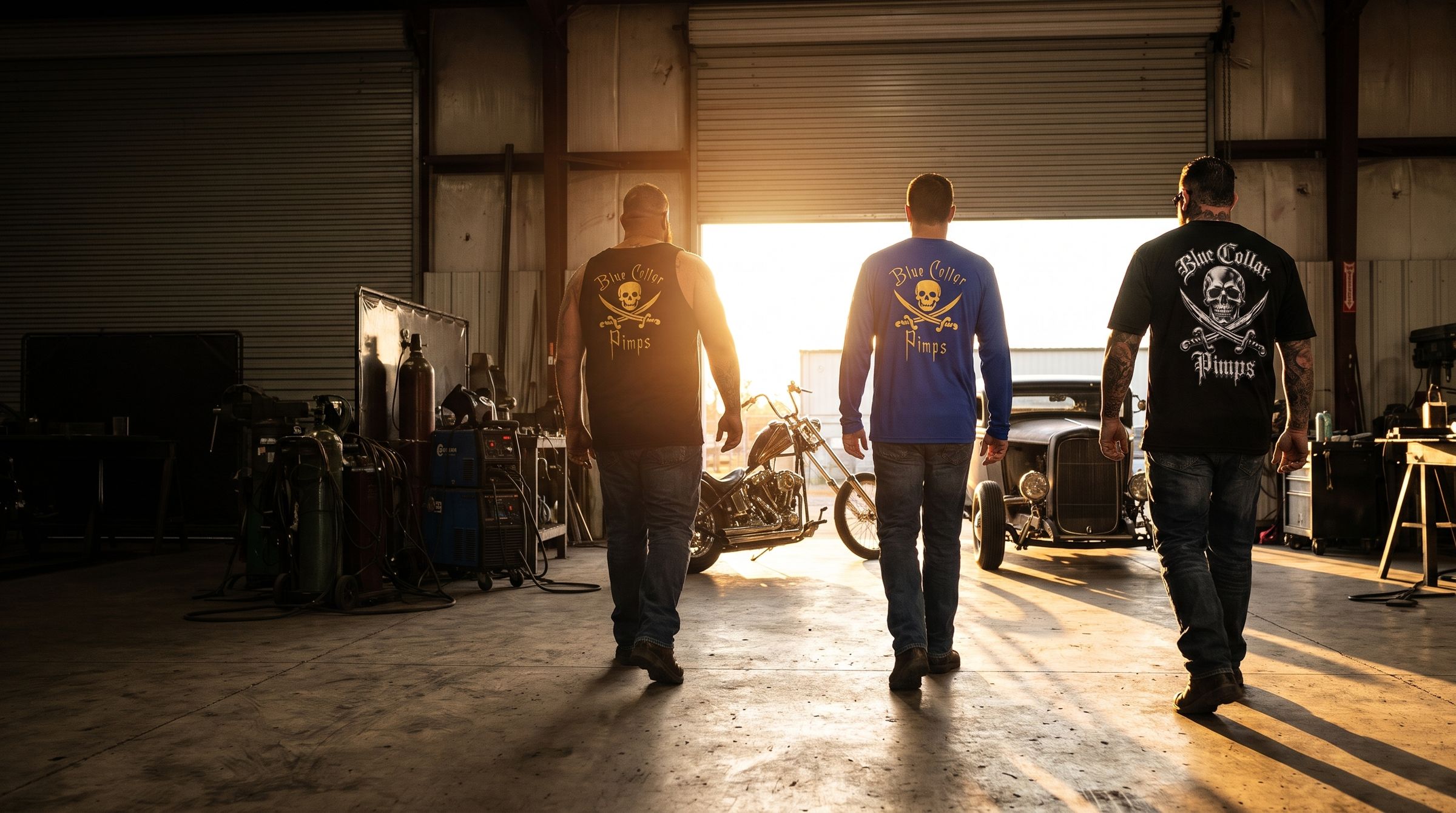 Three tradesmen in Blue Collar Pimps shirts walking out of a shop at sunset