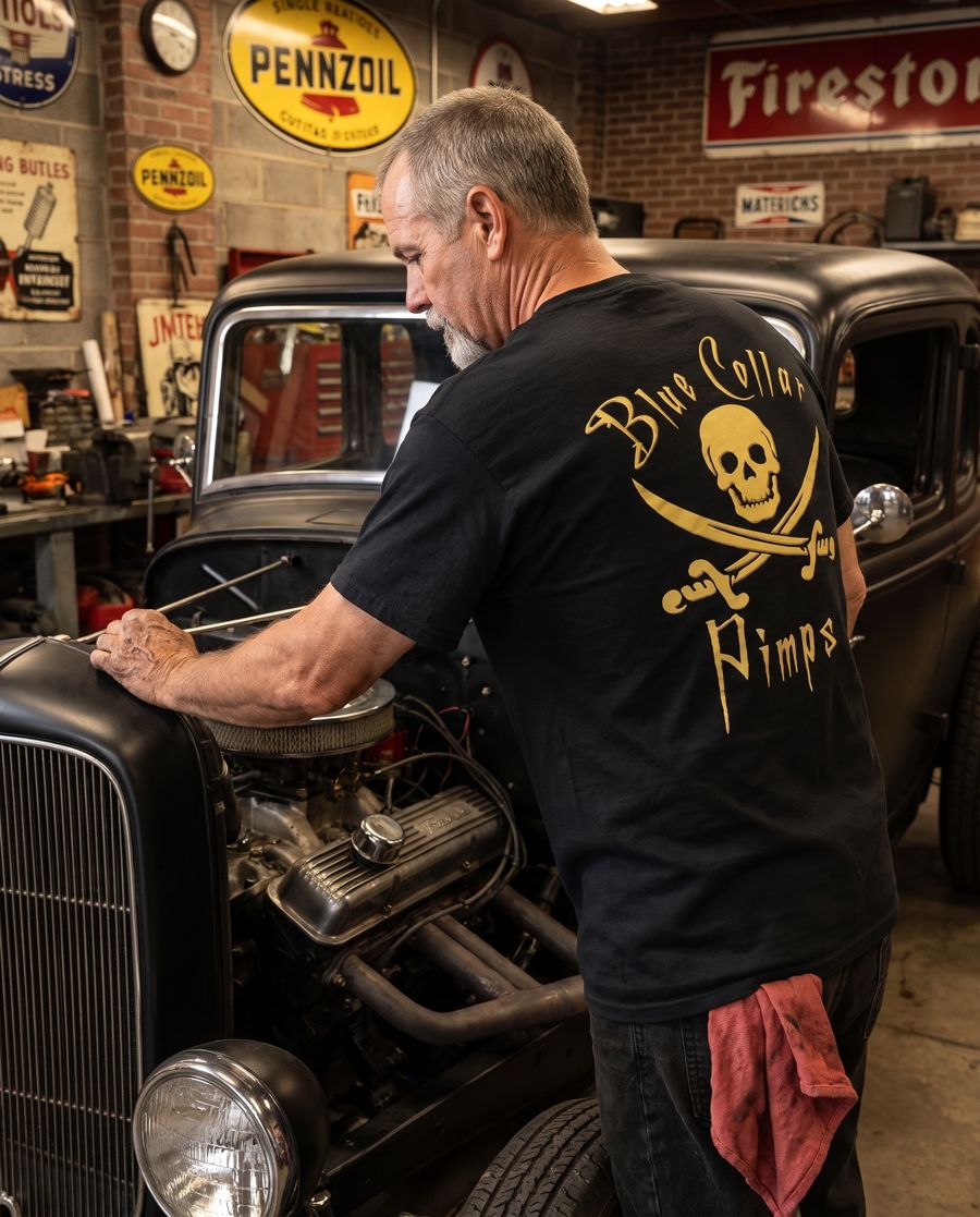 Mechanic in a black BCP tee working on a hot rod