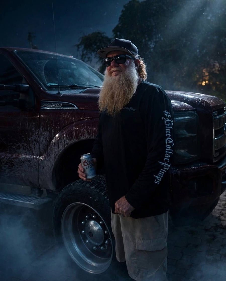 Bearded man in a black BCP long sleeve standing by his Ford F-250